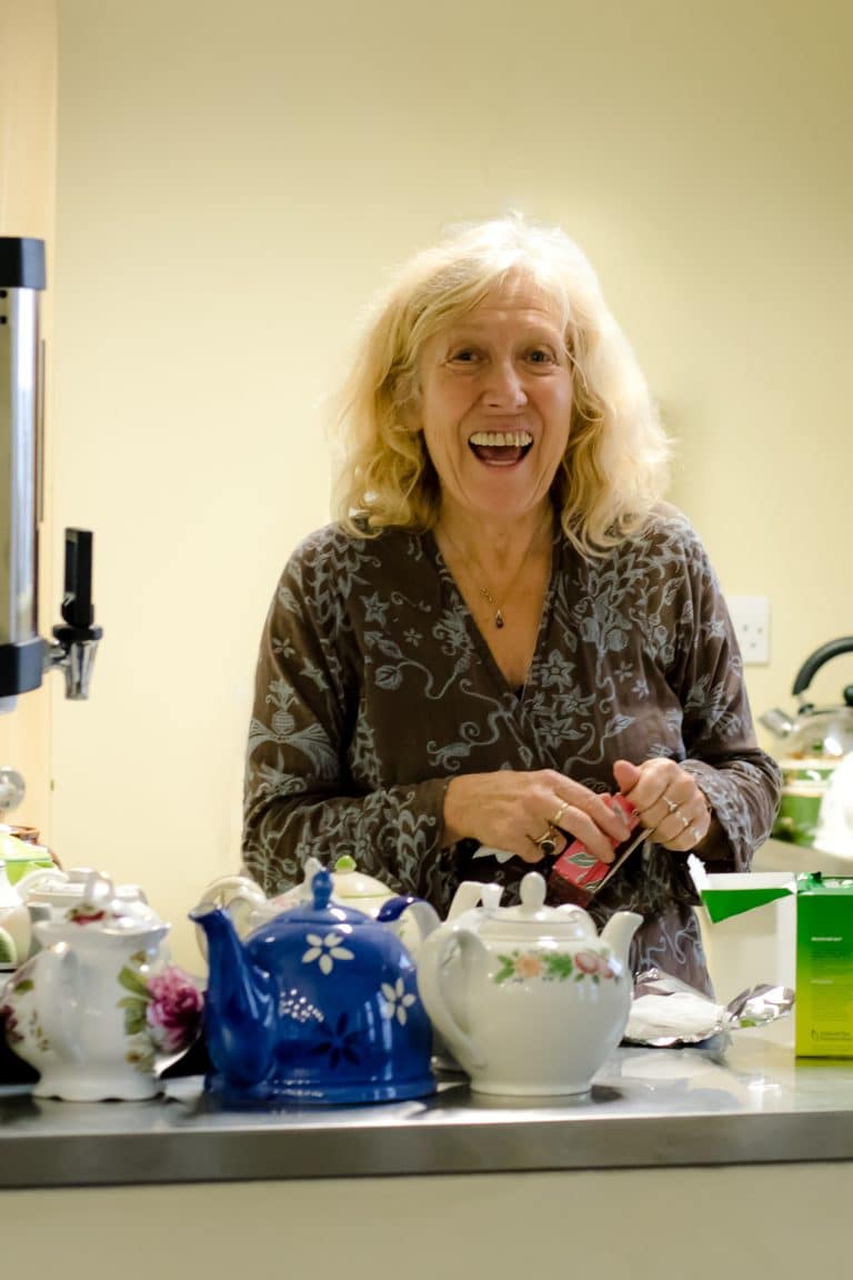 Image of Beyond the Page volunteer making tea and smiling